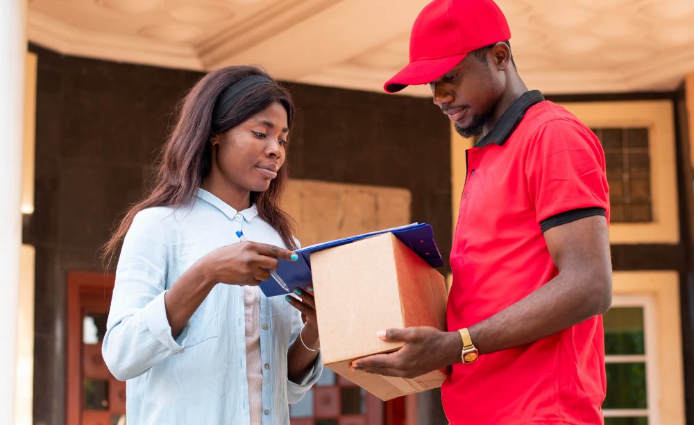 close-up-delivery-person-giving-parcel-client